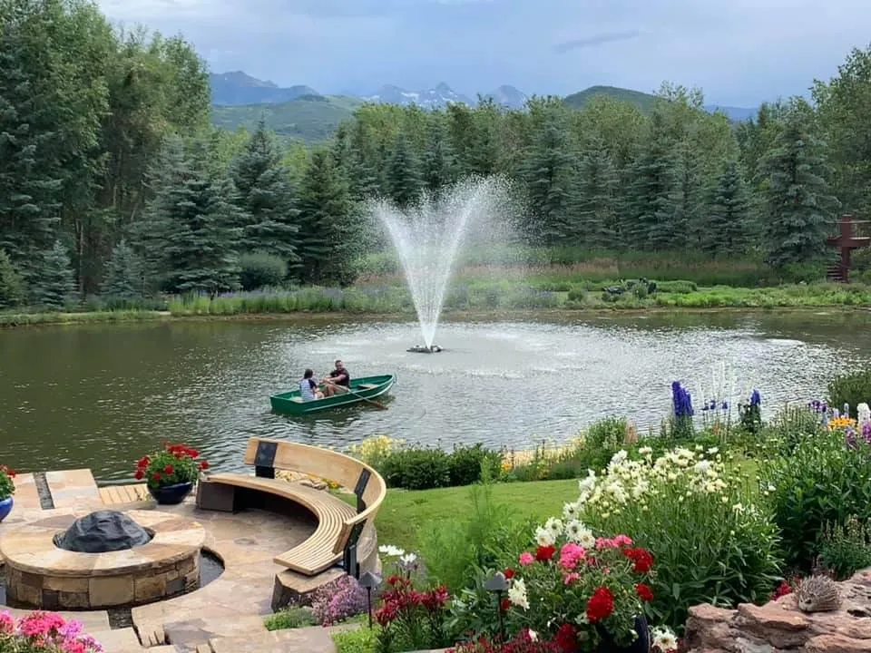 A rowboat on Fox Pond beside the fountain and the fire-pit terrace