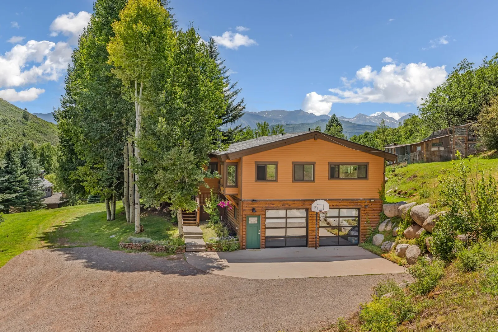 The guest house on Little Woody Creek Road in summer, mountains behind