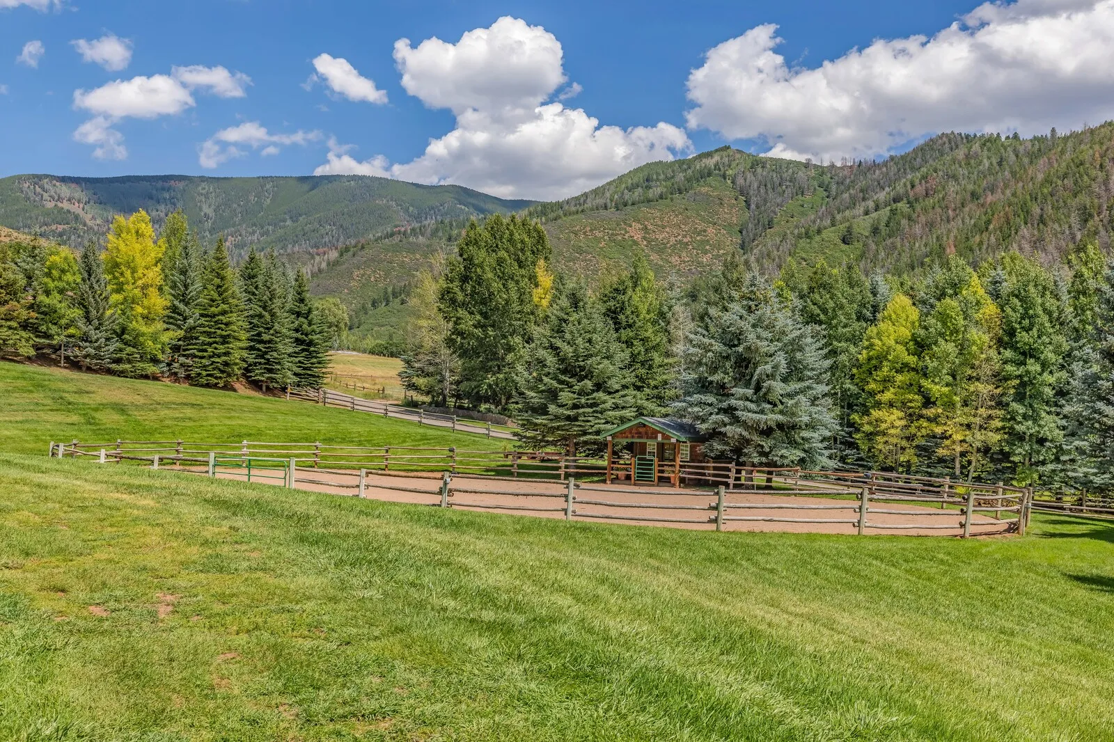 Pasture and the arena with the valley walls beyond