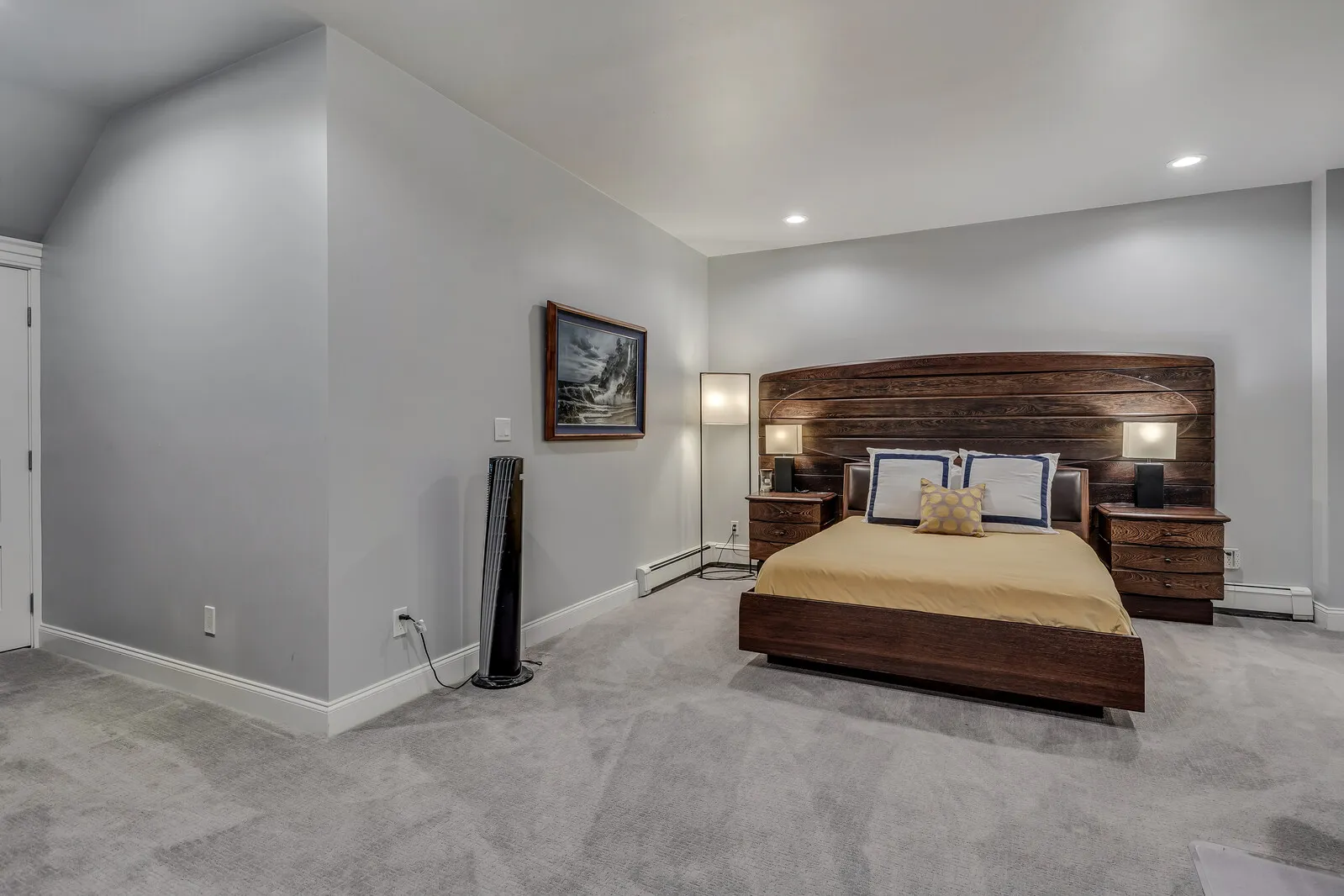 A queen bedroom with a reclaimed-wood headboard